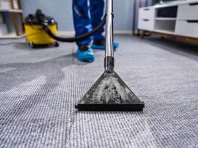 Photo Of Janitor Cleaning Carpet With Vacuum Cleaner